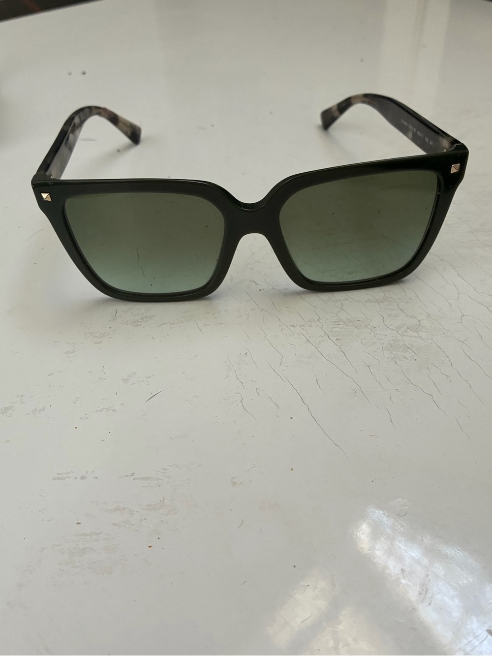 Valentino tortioshell sunglasses w a green lense and signature rockstuds on arms